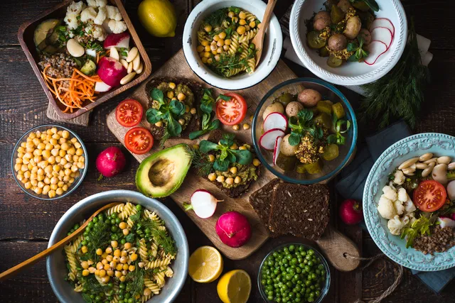 Different salad and snack on the wooden table top view.